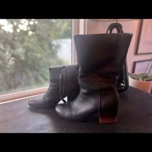 Stylish black mid calf boots.